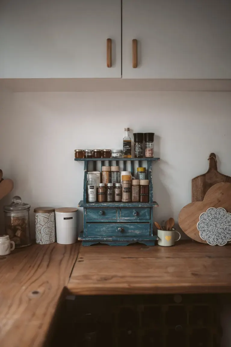 Rustic wooden countertop with neatly organized spice rack in home kitchen. Stock Photo