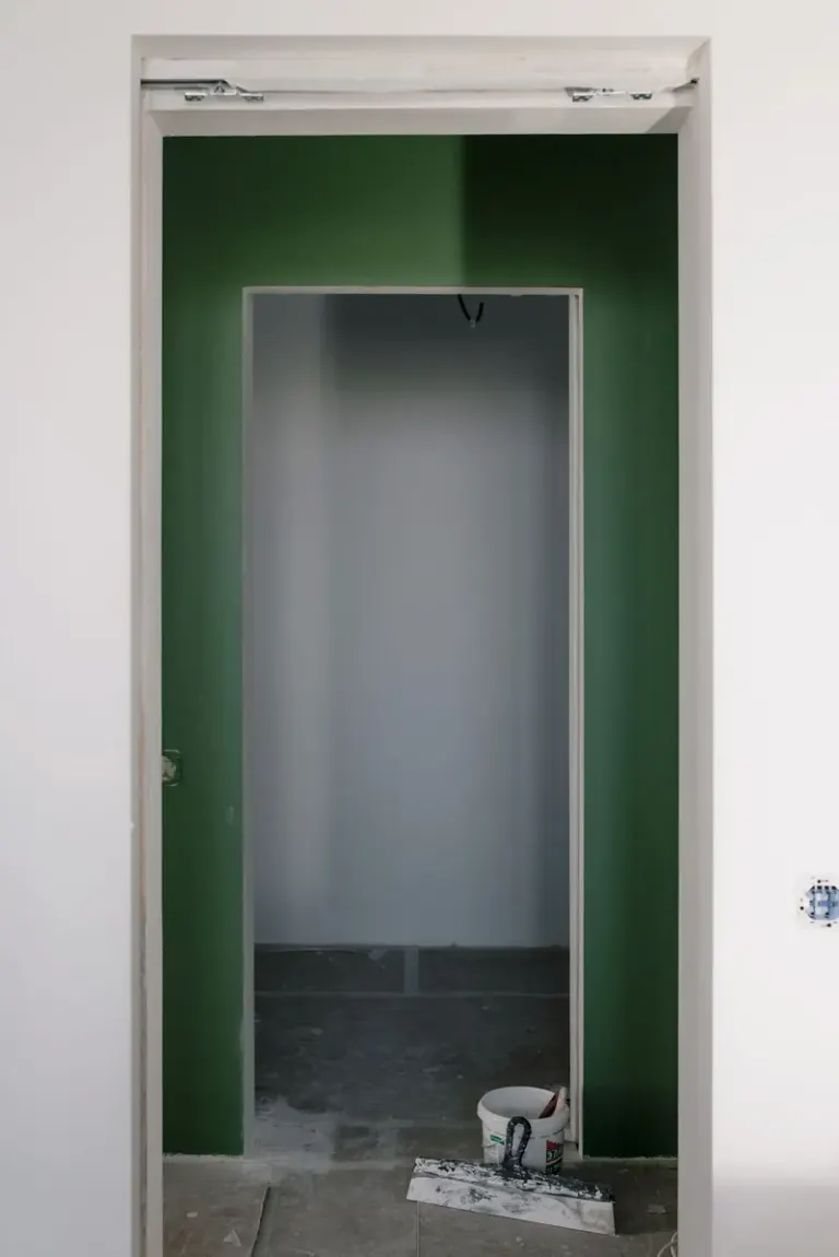 Empty doorway in new light apartment with colorful walls during repair work in daytime Stock Photo