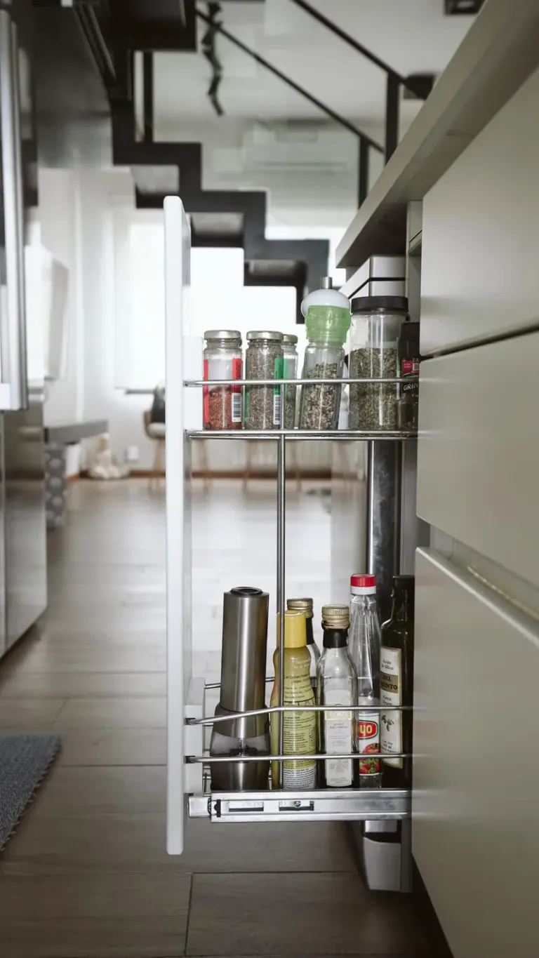 A sleek modern kitchen with a pull-out spice and oil storage drawer. Stock Photo