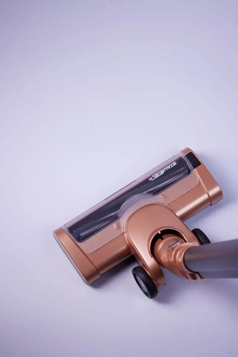 High-angle shot of a sleek vacuum cleaner on white flooring, perfect for cleaning themes. Stock Photo