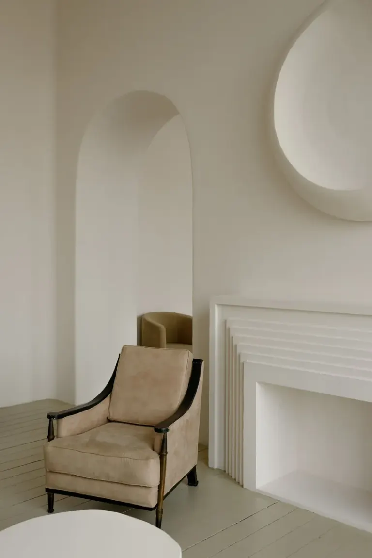 Elegant modern interior featuring a beige armchair and minimalist design elements. Stock Photo