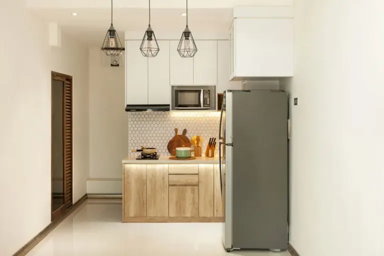 Stylish minimalist kitchen interior with wooden cabinets and sleek appliances. Stock Photo