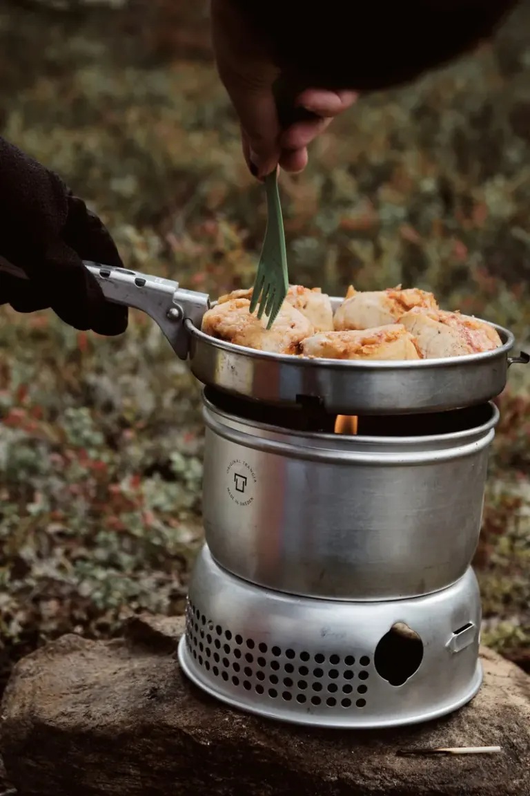 A close-up of cooking food using a portable stove outdoors in Sundsvall, Sweden. Stock Photo