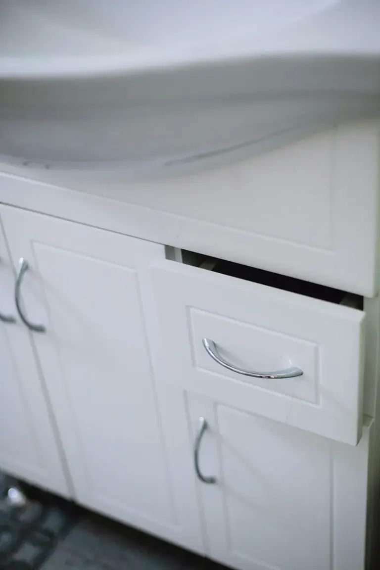 Close-up of a sleek white bathroom cabinet with drawer and sink in modern design. Stock Photo